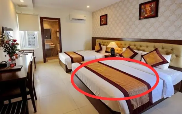 Little-Known Facts About the Dark-Colored Runner Placed Across Hotel Beds