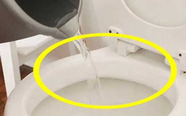 Check into a hotel and boil water and pour it into the toilet immediately