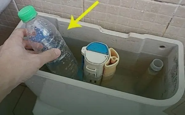 Put a plastic bottle in the toilet tank