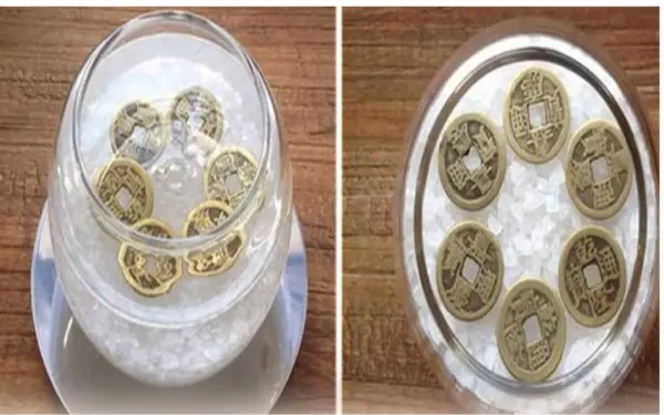 Cup of water with salt and coins