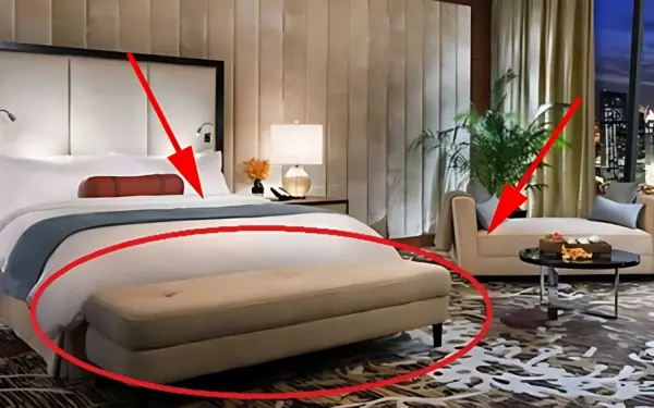 Why hotel rooms have a chair at the end of the bed