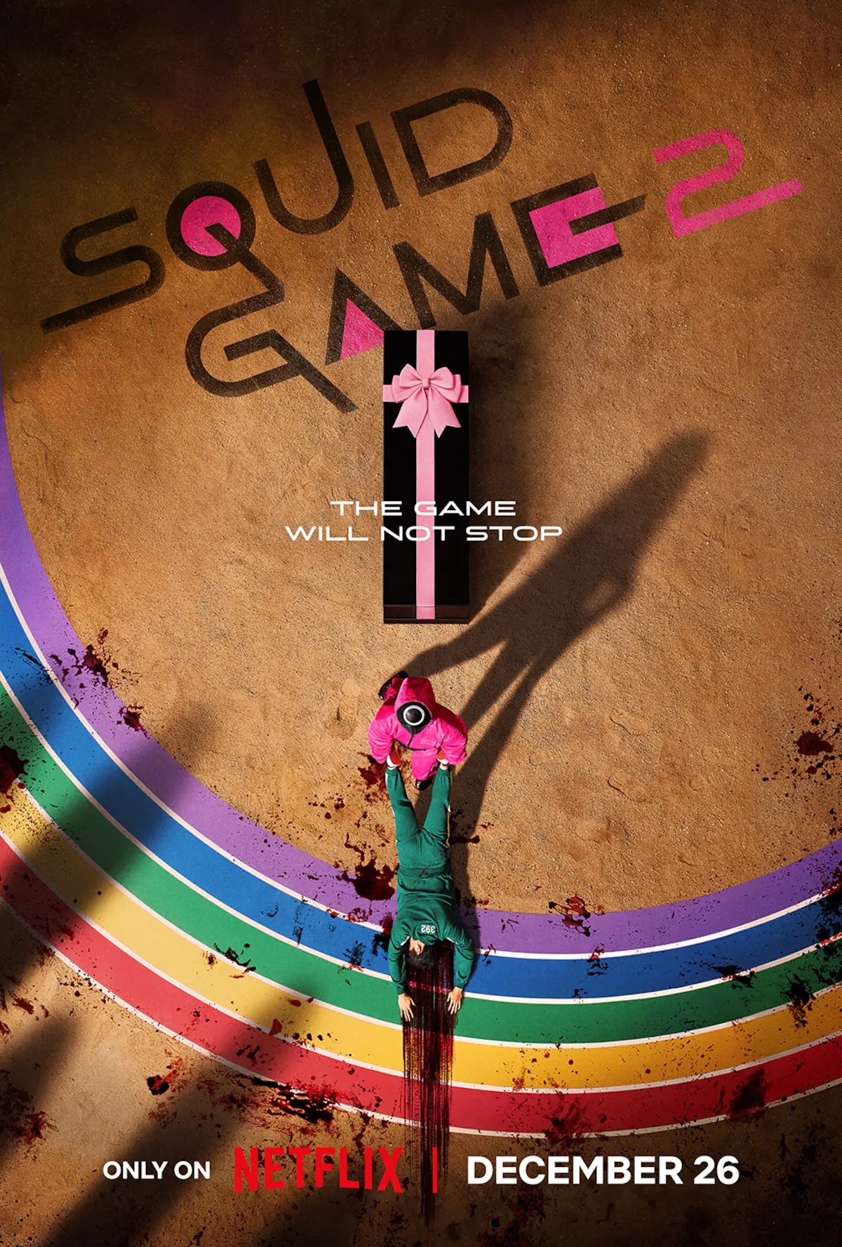 Key art from Squid Game Season 2 shows a man in a pink jumpsuit dragging a body