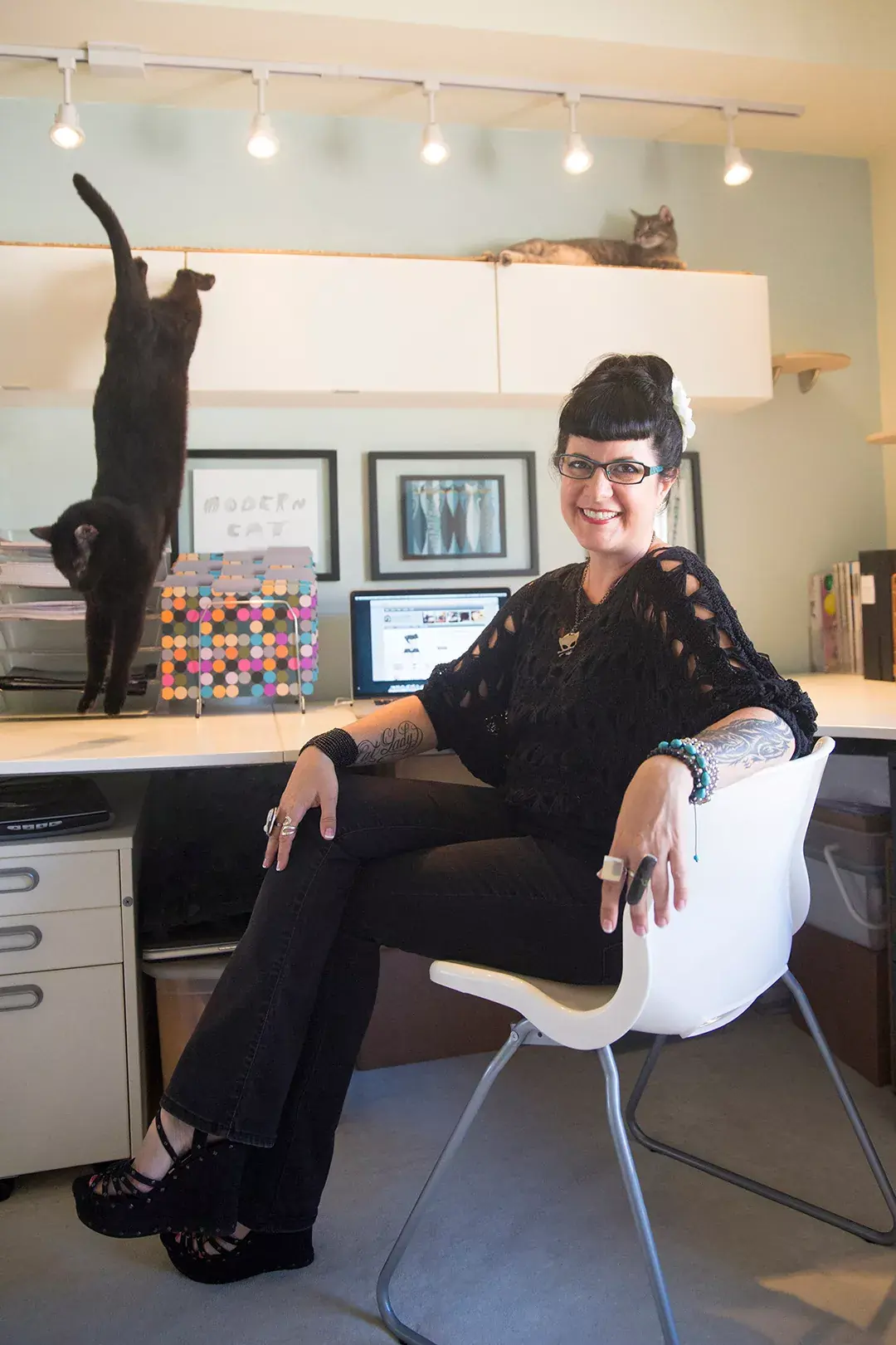 Kate Benjamin and her emotional support cat in her home office
