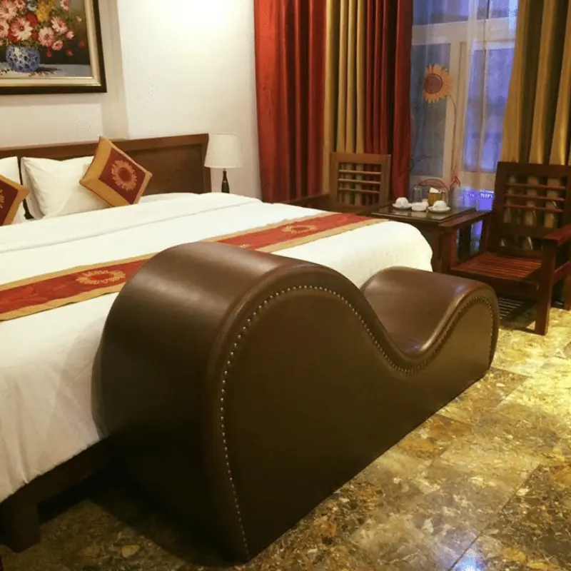 Why hotel rooms have a chair at the end of the bed