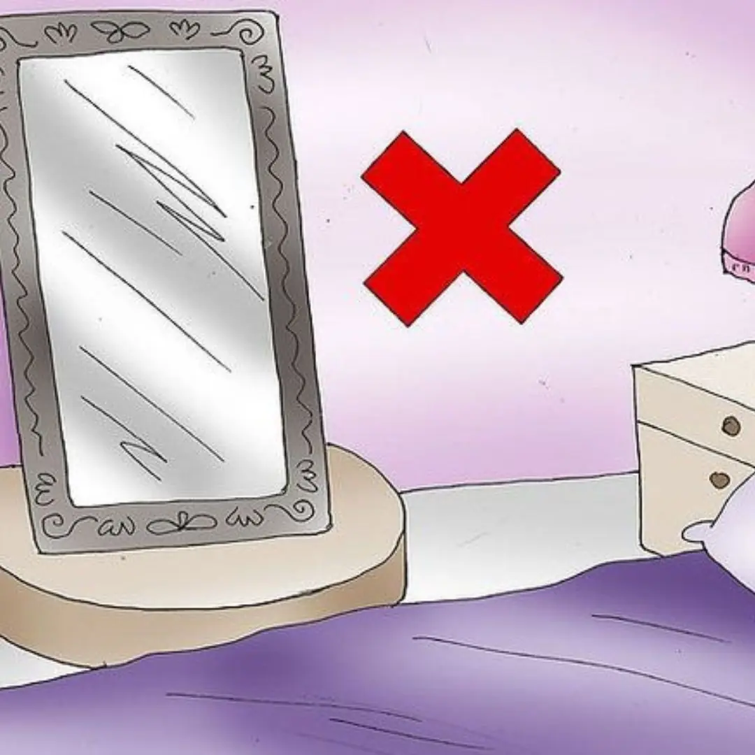 Why should not hang a mirror opposite the bed?