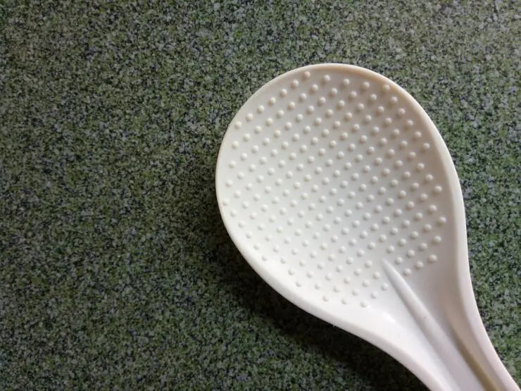 Why does the rice cooker's rice scoop have round dots?