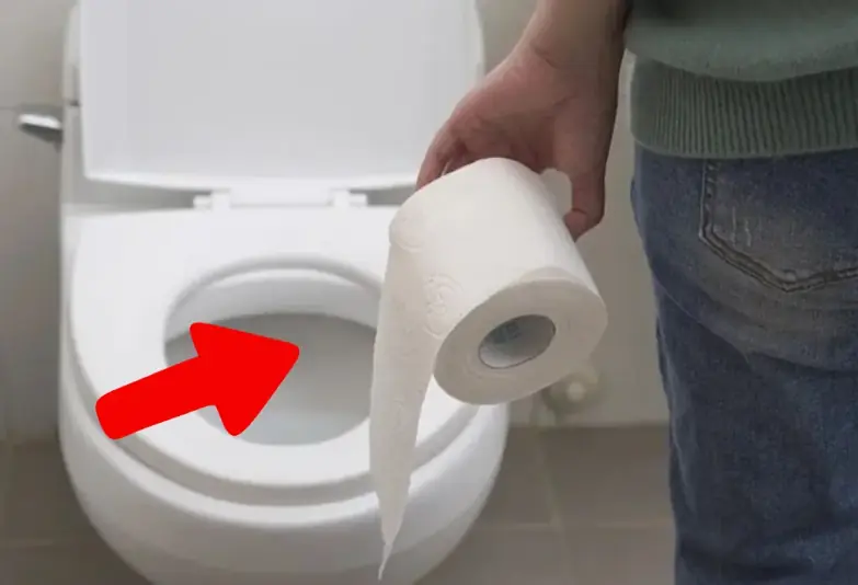 Why should you put a piece of paper in the toilet before using it?