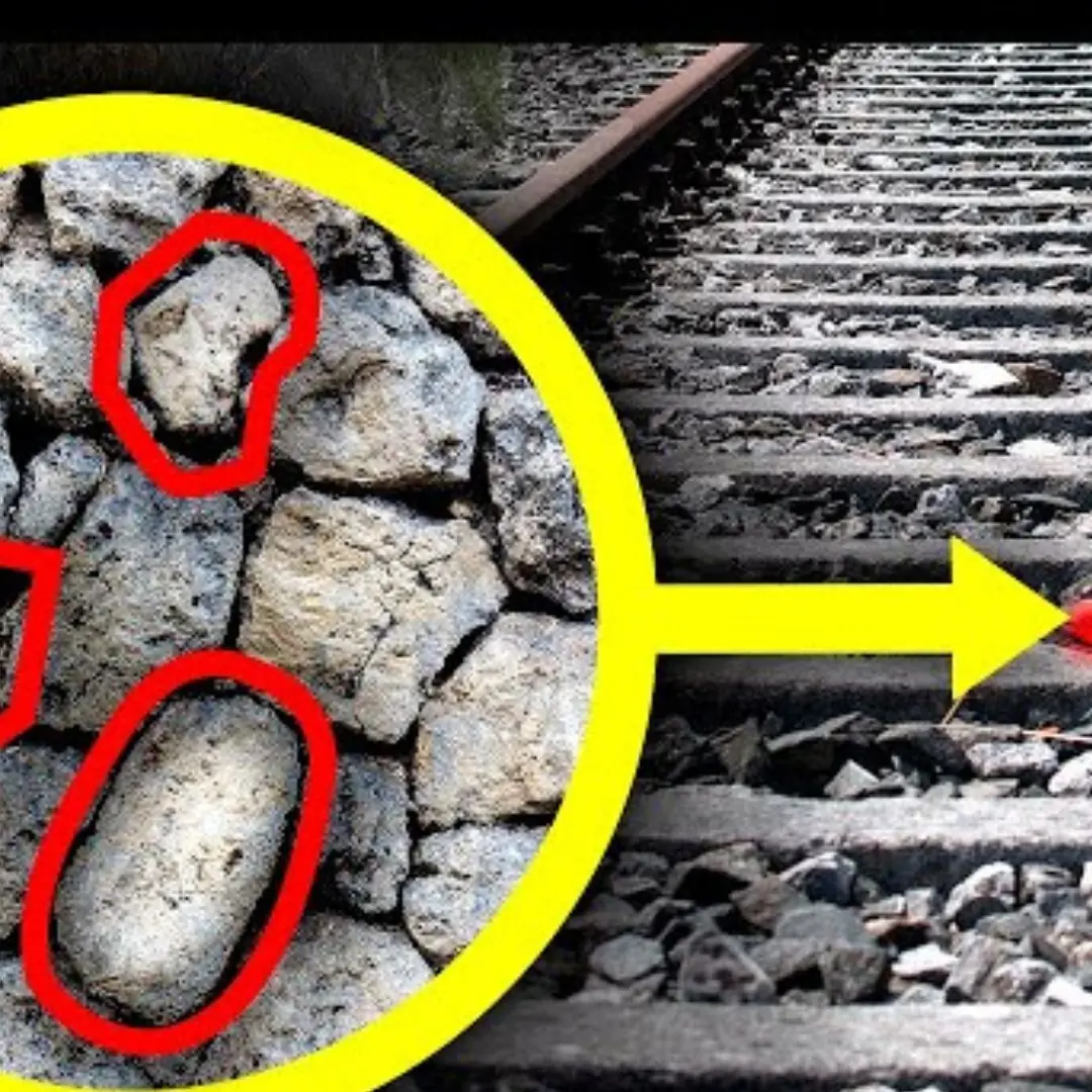 Why are rocks spread along railway tracks?