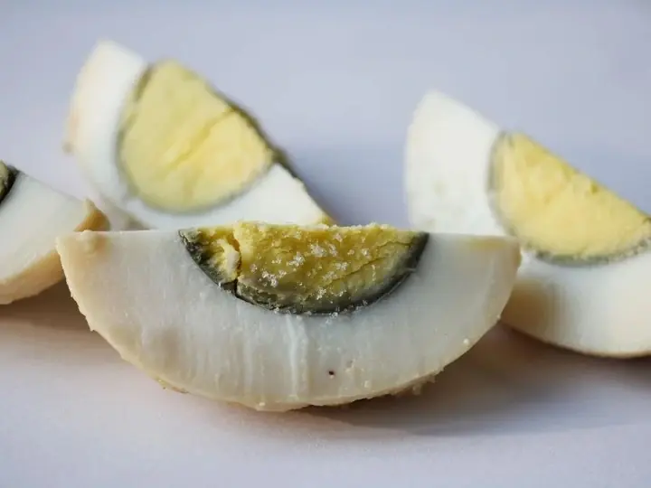 Why does a green ring form around hard-boiled egg yolks?