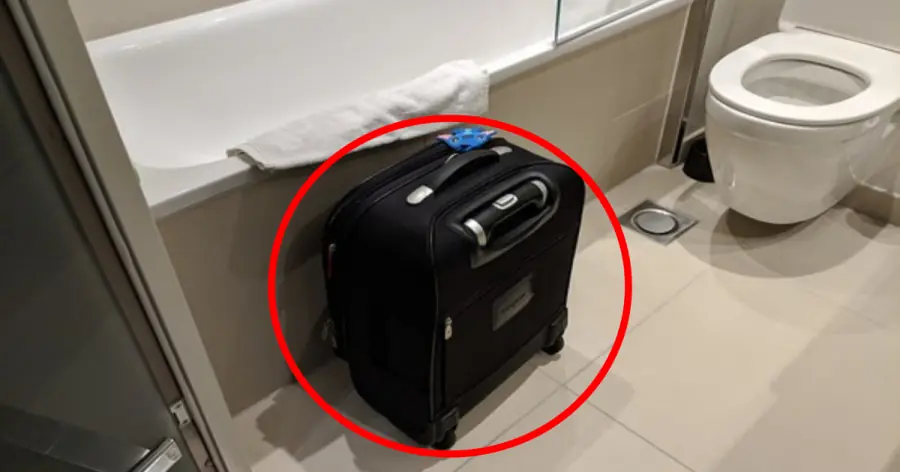 Why is it recommended to place your suitcase in the bathtub when you arrive at a hotel?