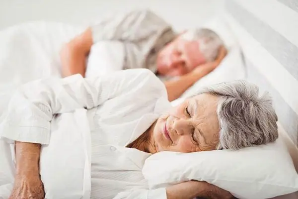 Why do many couples choose separate sleeping arrangements after turning 50?