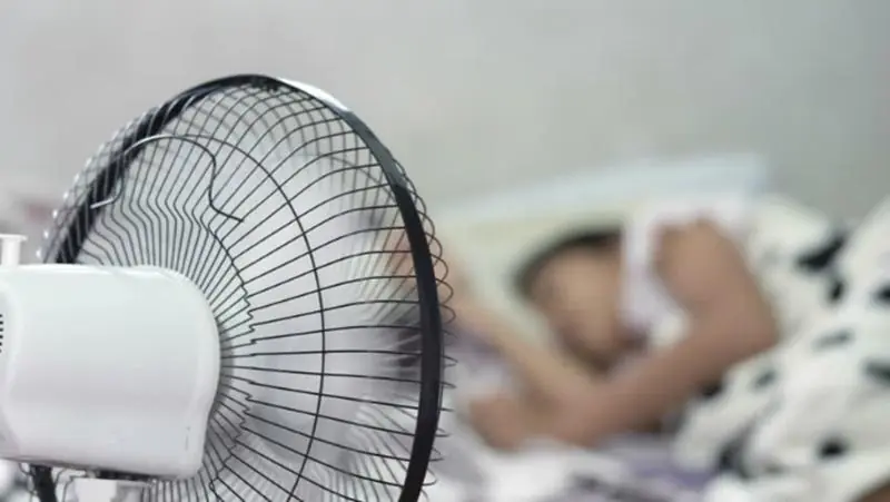 Should You Sleep With a Fan Running All Night During Extreme Heat? Experts Finally Explain