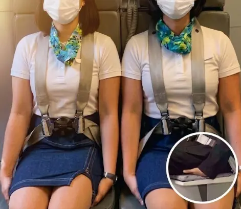 Why You May See Cabin Crew Sitting With Their Hands Tucked Under Their Thighs