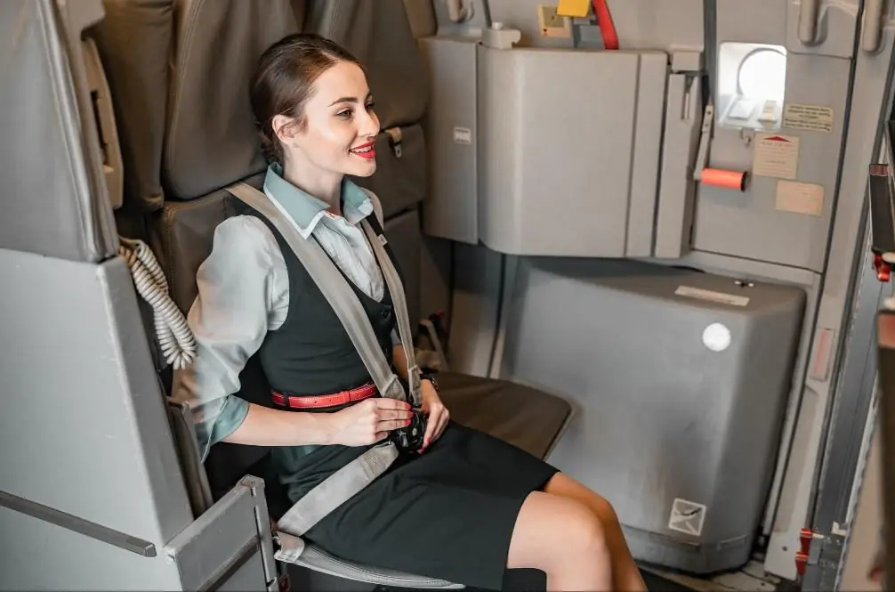 Why Flight Attendants Sit on Their Hands During Takeoff and Landing: The Surprising Safety Reason