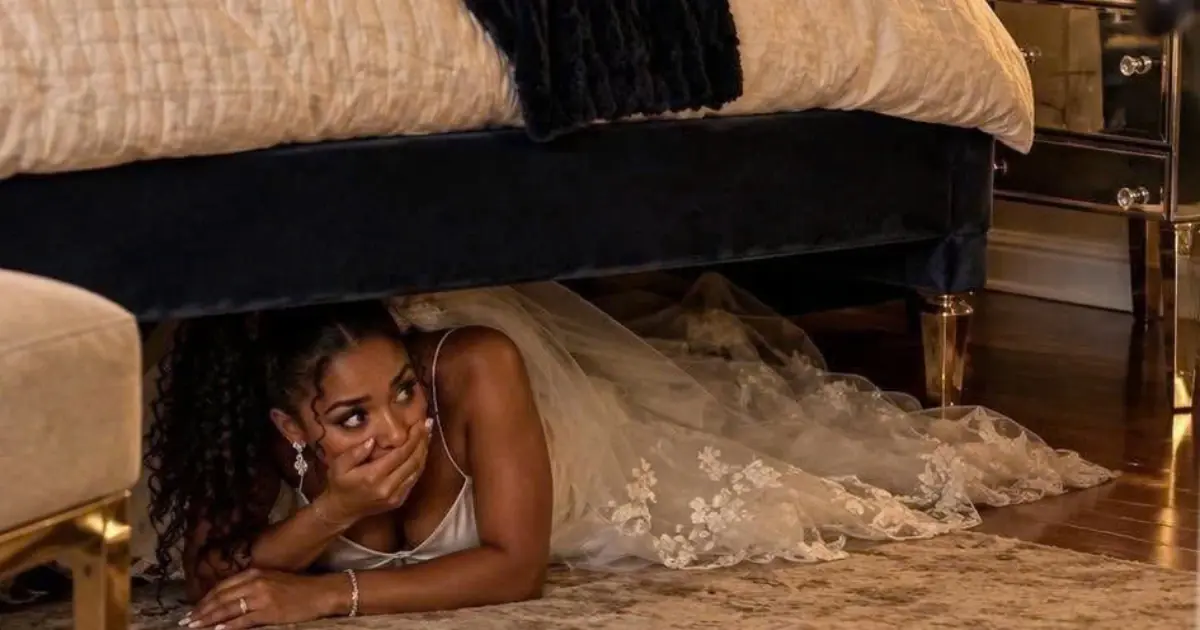 On my wedding night I hid under the bed to surprise my husband. His mother came in instead, sat down on the mattress above me, and put a call...
