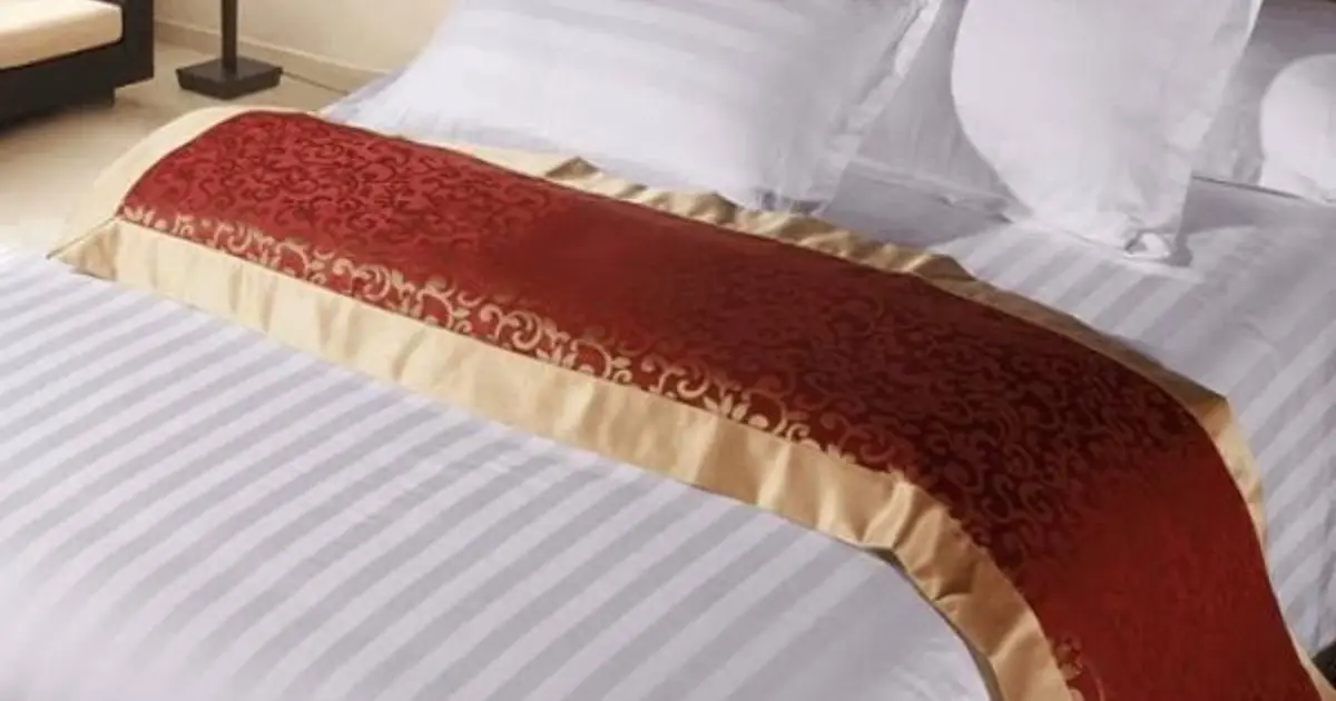 Ever Wondered Why Hotels Place a Cloth Across the Bed? Here’s What It’s Really For